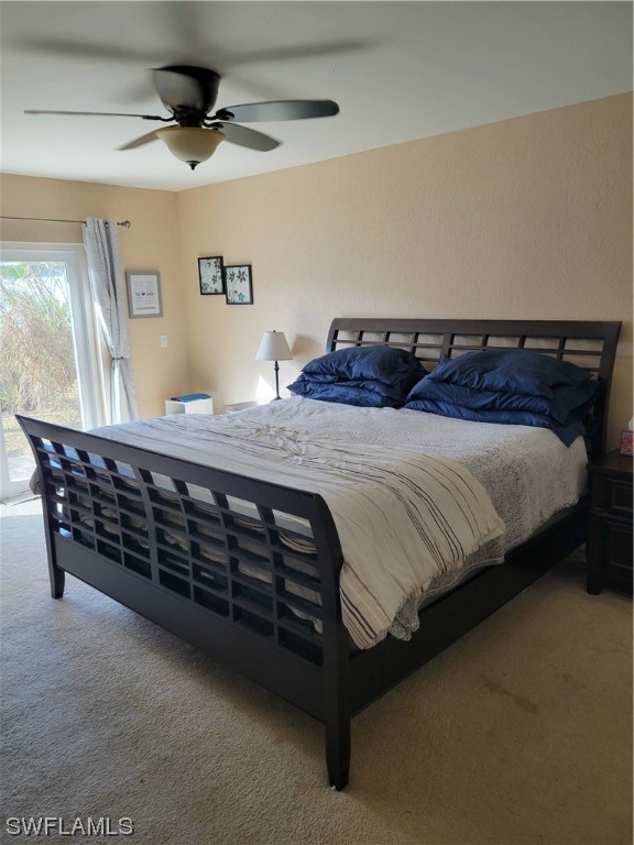 17520 Braddock Road Fort Myers, FL 33967 - Photo 16 of 31 a bedroom with a bed a chandelier and dresser