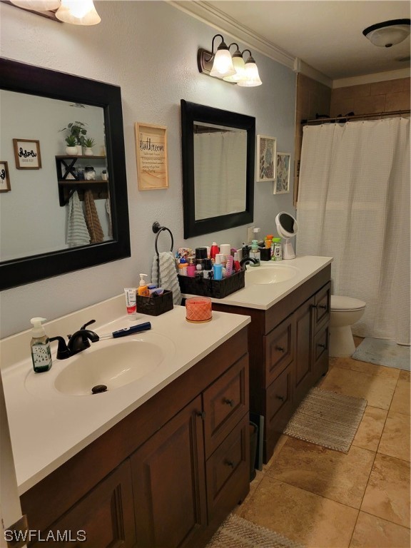 17520 Braddock Road Fort Myers, FL 33967 - Photo 17 of 31 a bathroom with a double vanity sink mirror and toilet