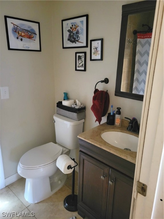 17520 Braddock Road Fort Myers, FL 33967 - Photo 23 of 31 a bathroom with a toilet a sink and mirror