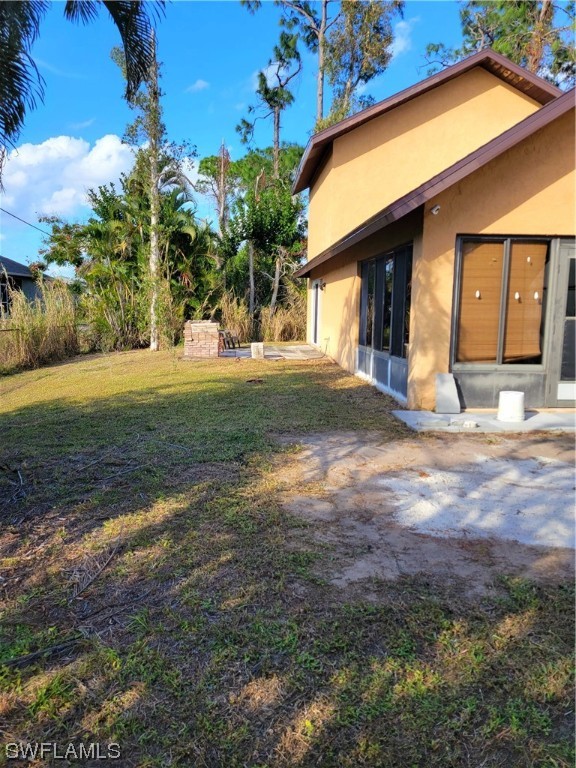 17520 Braddock Road Fort Myers, FL 33967 - Photo 30 of 31 a front view of a house with a yard and garage
