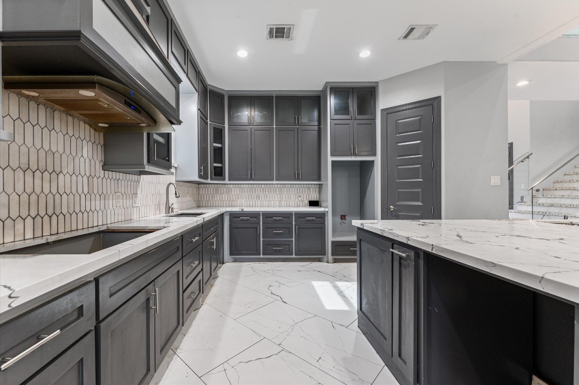 5215 Kelso Street Houston, TX 77021 - Photo 11 of 47 a kitchen with stainless steel appliances kitchen island granite countertop a sink and cabinets