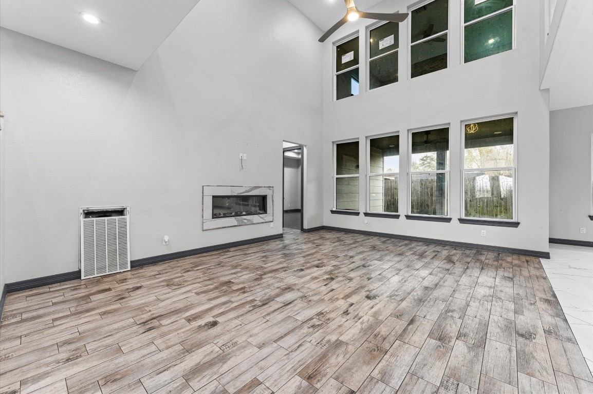 5215 Kelso Street Houston, TX 77021 - Photo 20 of 47 a view of an empty room with wooden floor and a fireplace