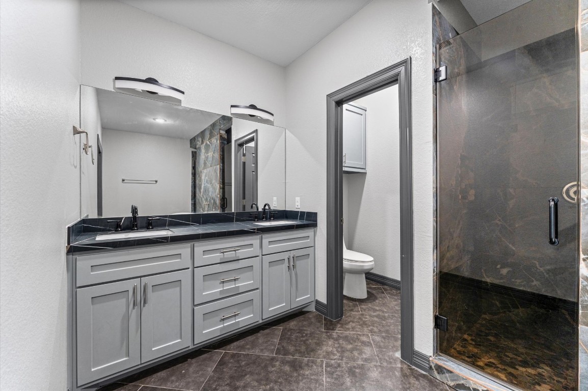 5215 Kelso Street Houston, TX 77021 - Photo 23 of 47 a bathroom with a granite countertop sink toilet and shower