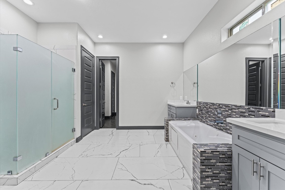 5215 Kelso Street Houston, TX 77021 - Photo 39 of 47 a spacious bathroom with a double vanity sink a mirror and a shower
