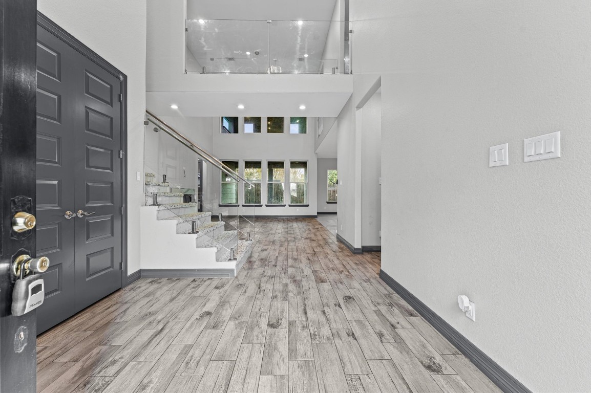 5215 Kelso Street Houston, TX 77021 - Photo 4 of 47 a view of a hallway with wooden floor and staircase