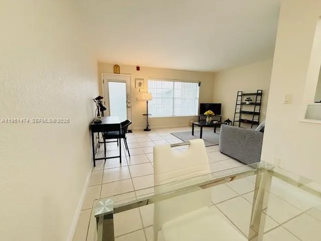 a living room with furniture a dining table and chairs with wooden floor