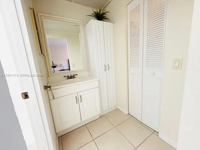 a bathroom with a sink vanity and a mirror
