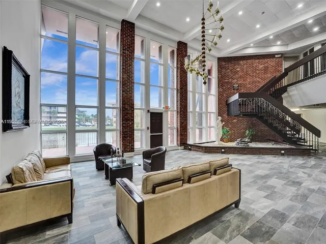 a living room with furniture and large windows