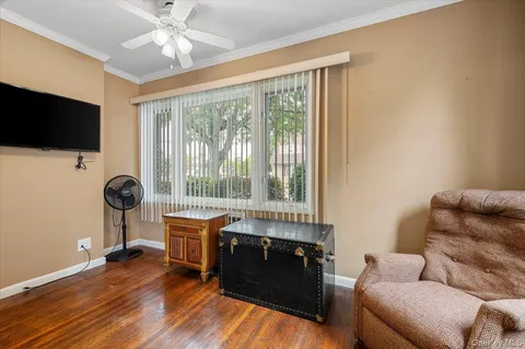 a view of a a dining room with furniture window and wooden floor
