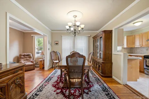 a living room with furniture a chandelier and a window