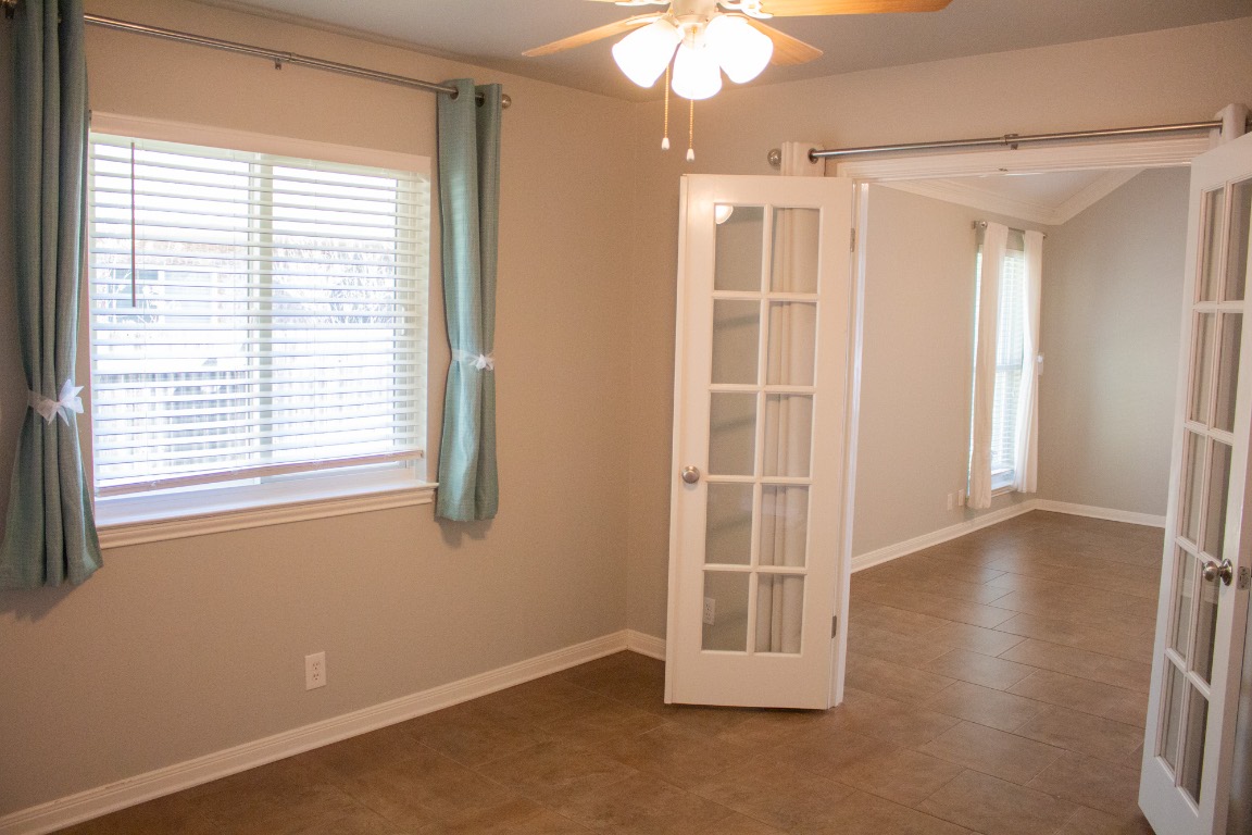 12721 Oxen Way Austin, TX 78732 - Photo 12 of 37 a view of an empty room with window and chandelier fan