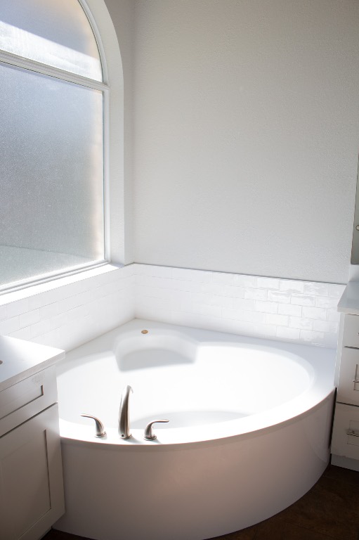 12721 Oxen Way Austin, TX 78732 - Photo 18 of 37 a white bath tub sitting in a bathroom