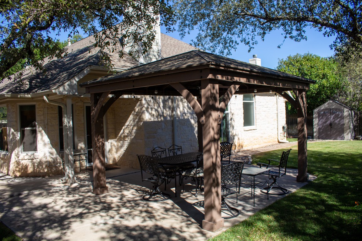 12721 Oxen Way Austin, TX 78732 - Photo 26 of 37 a view of a chair and table in backyard of the house