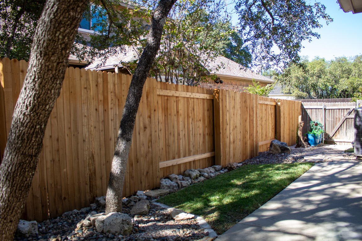 12721 Oxen Way Austin, TX 78732 - Photo 29 of 37 a backyard of a house with lots of green space
