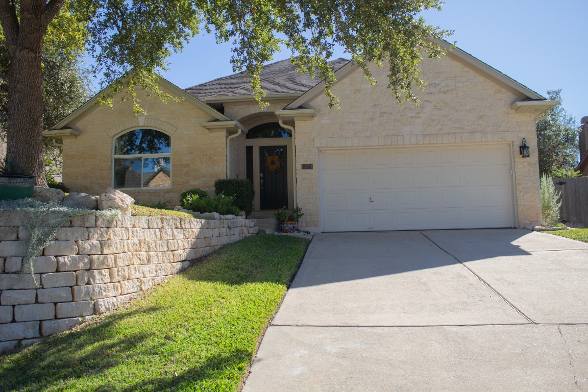 12721 Oxen Way Austin, TX 78732 - Photo 31 of 37 a front view of a house with garden