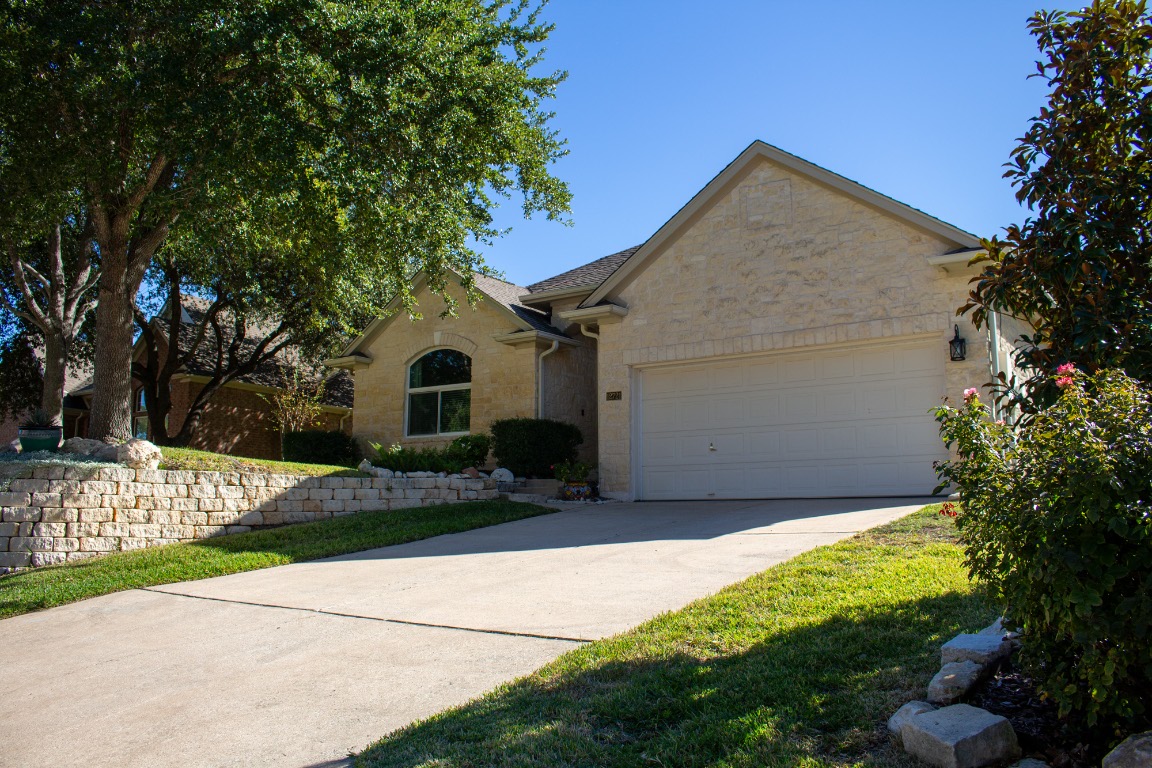 12721 Oxen Way Austin, TX 78732 - Photo 32 of 37 a front view of a house with a yard