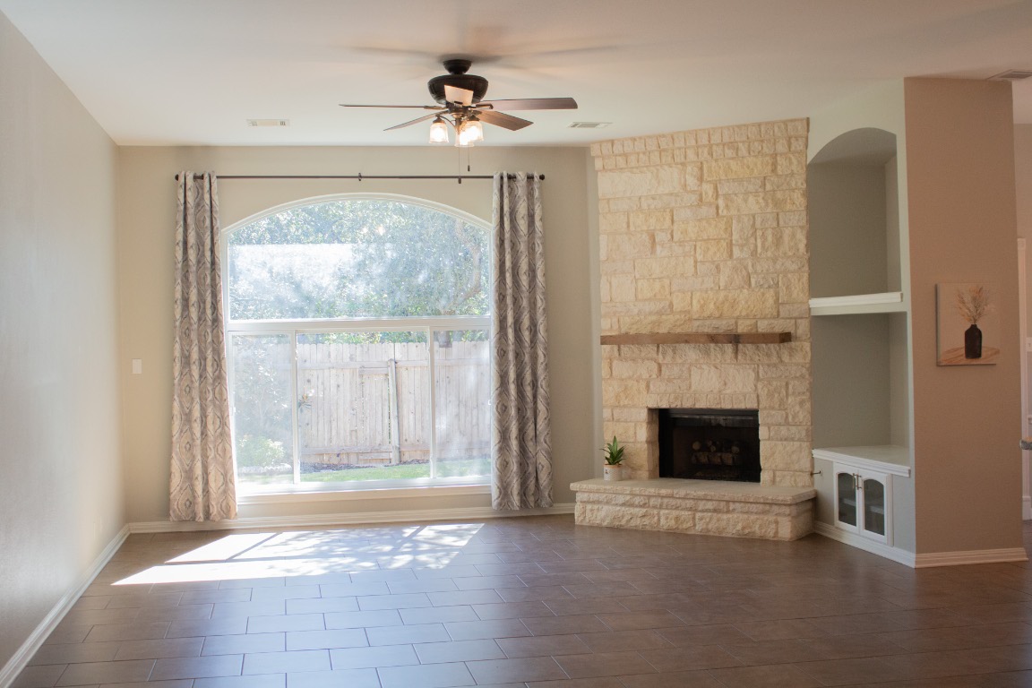 12721 Oxen Way Austin, TX 78732 - Photo 4 of 37 a view of an empty room with fireplace and a window