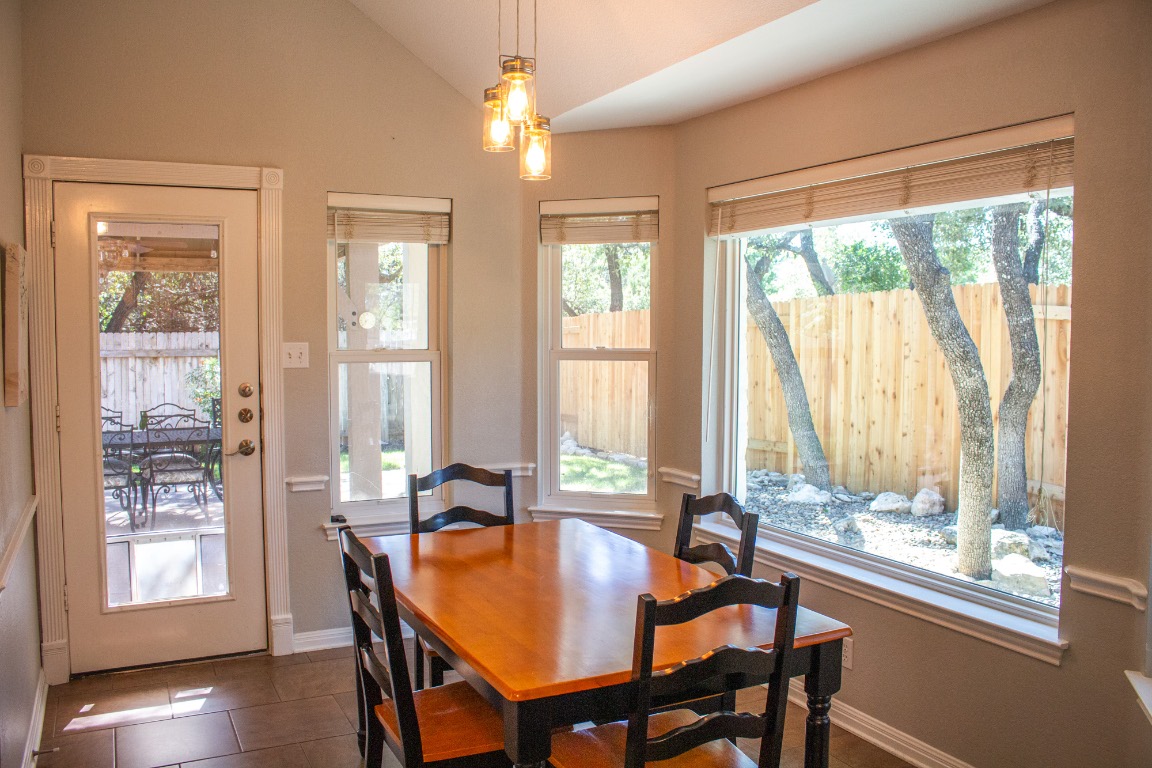 12721 Oxen Way Austin, TX 78732 - Photo 6 of 37 a view of a dining room with furniture window and wooden floor