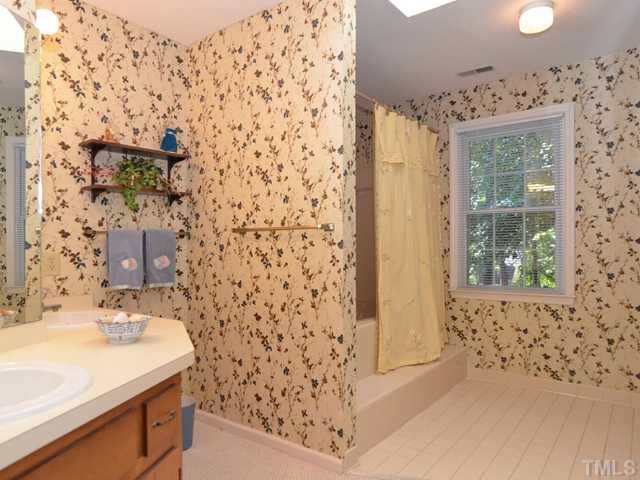 909 Bridge Way Raleigh, NC 27615 - Photo 14 of 22 a bathroom with a sink and a mirror