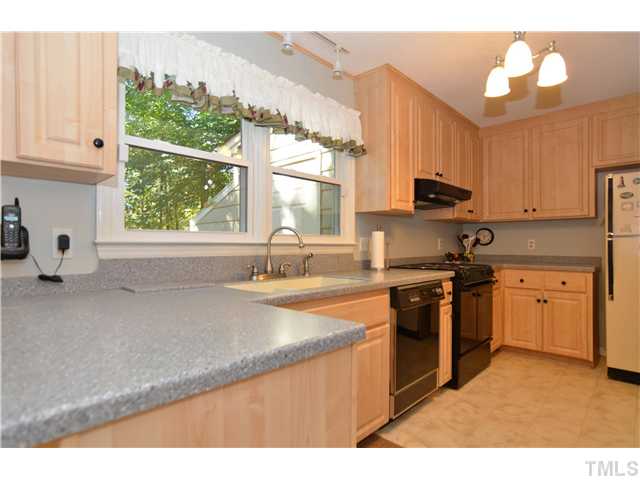 909 Bridge Way Raleigh, NC 27615 - Photo 7 of 22 a kitchen with stainless steel appliances granite countertop a sink a stove and a refrigerator