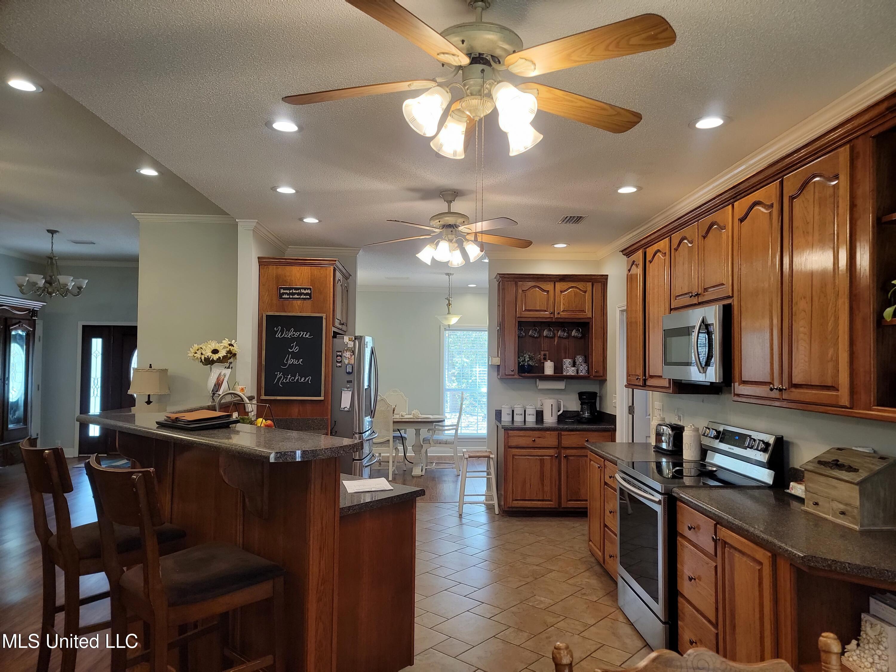 5540 Roxane Street Gautier, MS 39553 - Photo 5 of 35 Kitchen looking into dining & to front