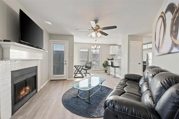 a living room with furniture a fireplace and a flat screen tv