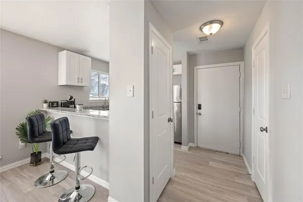 a kitchen with stainless steel appliances granite countertop a refrigerator and cabinets
