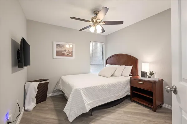 a bedroom with a bed and a chandelier