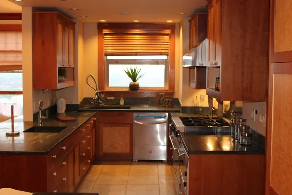 a kitchen with a sink a stove and a window