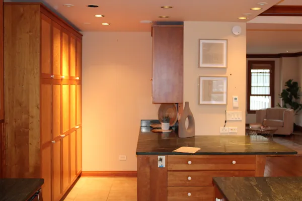 a kitchen with granite countertop a sink and cabinets