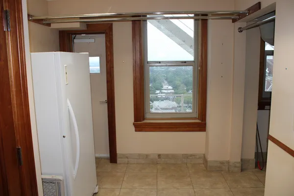 a view of an empty room with a mirror