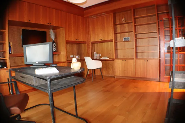 a living room with a table chair and a dining table