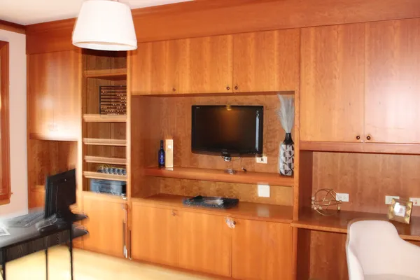 a living room with a flat screen tv furniture and a fireplace