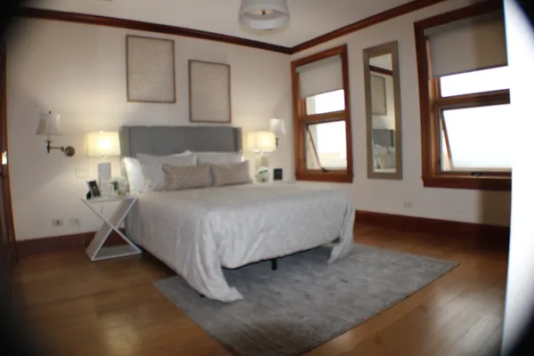 a bedroom with a bed and a mirror
