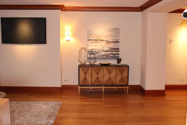 a view of a room with wooden floor and windows