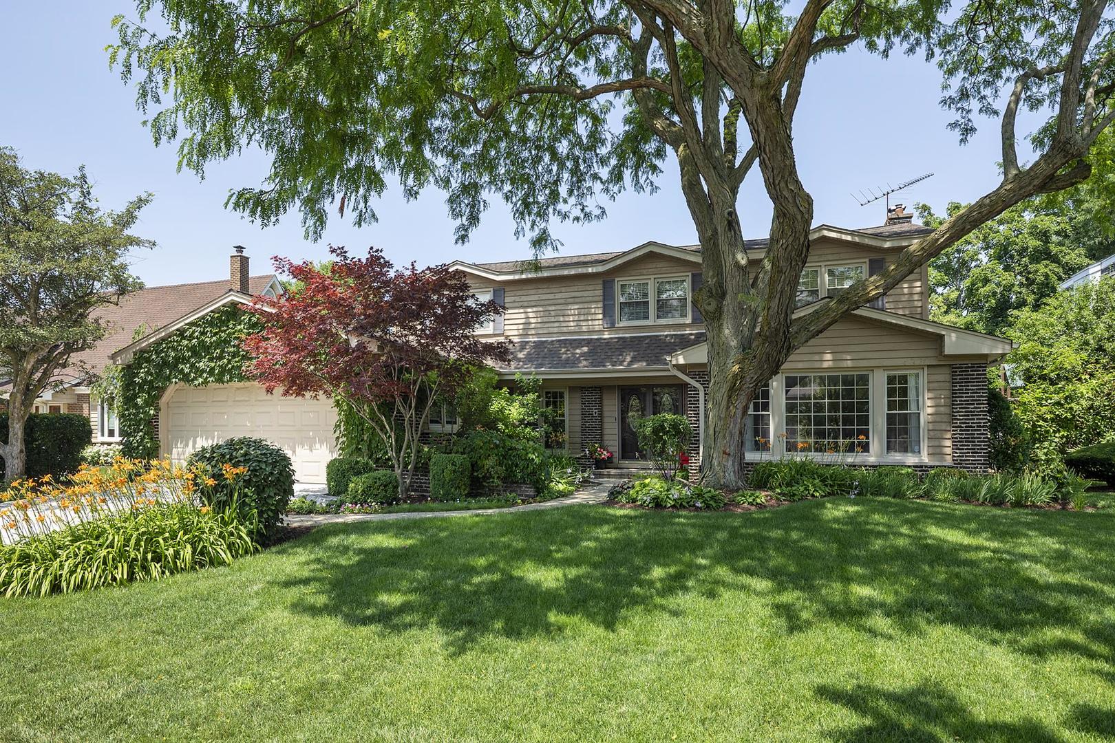 3956 Rutgers Lane Northbrook, IL 60062 - Photo 1 of 41 a front view of a house with a yard and trees