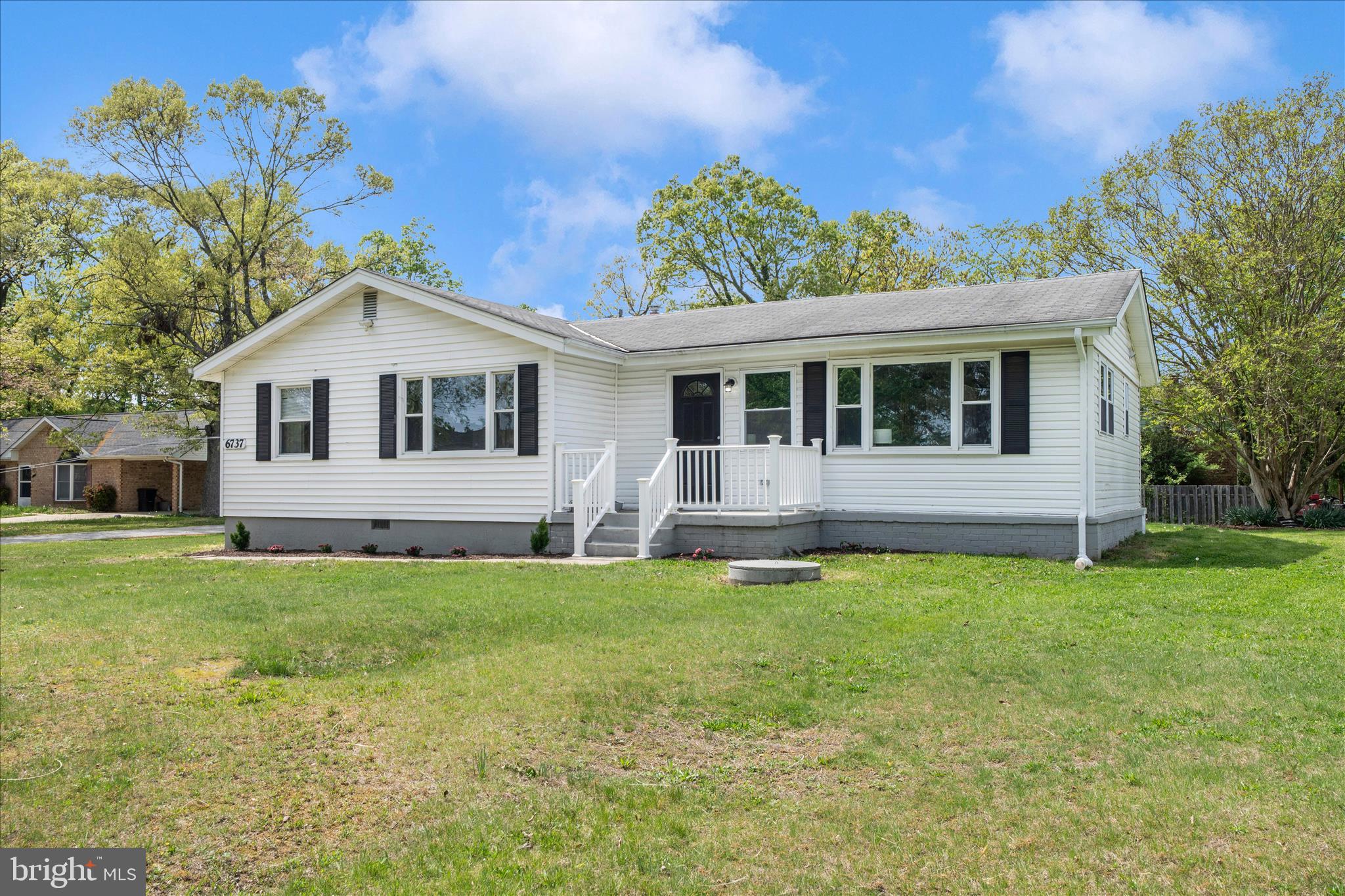 6737 Allentown Road Temple Hills, MD 20748 - Photo 2 of 51 a front view of a house with a garden and porch