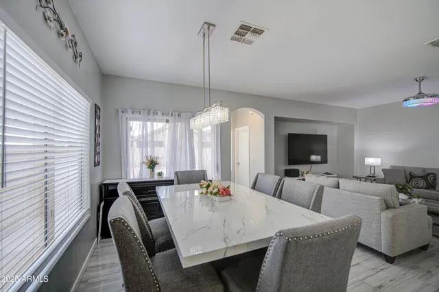 a view of a a dining room with furniture window and wooden floor