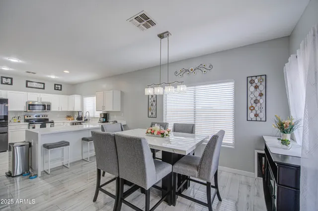 a dining room with furniture and window