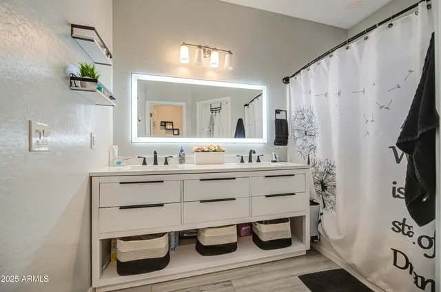 a bathroom with a sink mirror and vanity