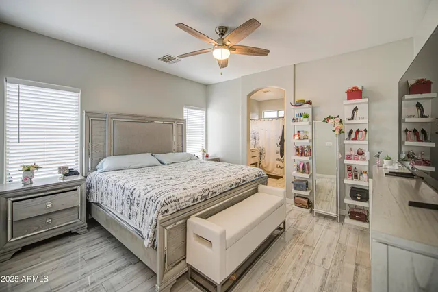 a bedroom with a bed and a ceiling fan