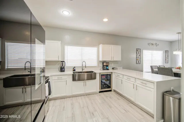 a kitchen with a stove a sink a refrigerator and cabinets