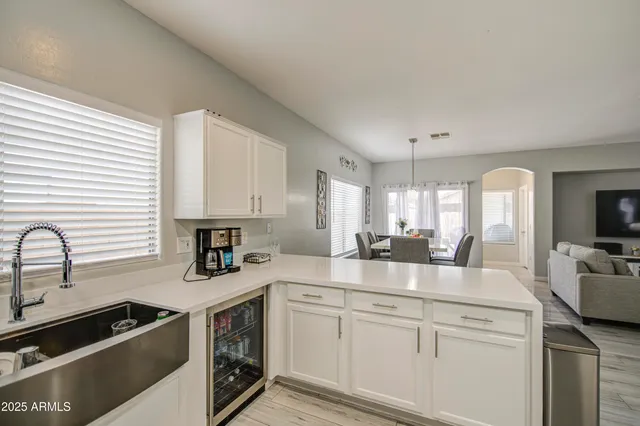 a kitchen with stainless steel appliances granite countertop a sink a stove and cabinets