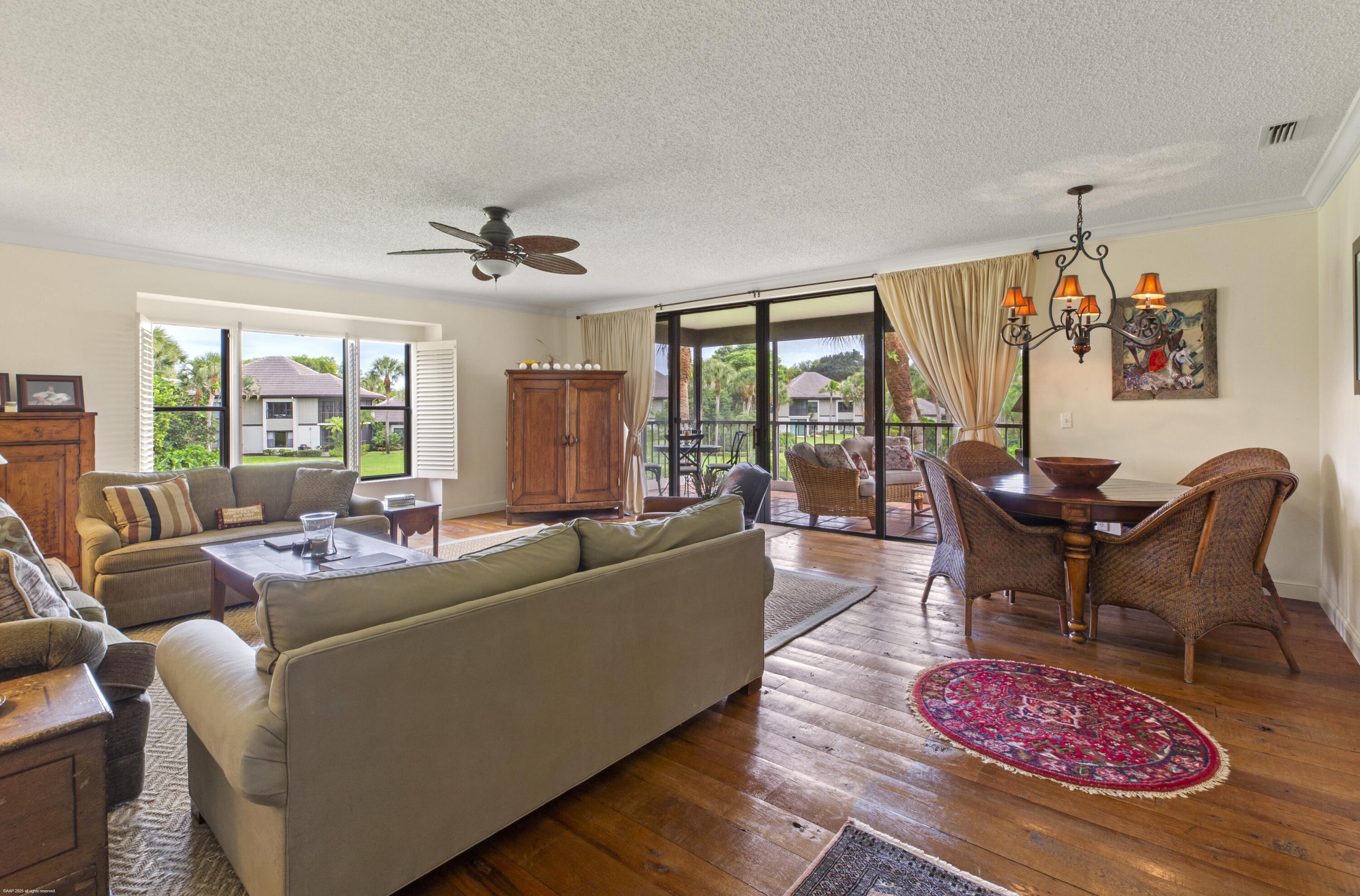 13244 Polo Club Road, Unit C206 Wellington, FL 33414 - Photo 11 of 46 a living room with furniture and a large window