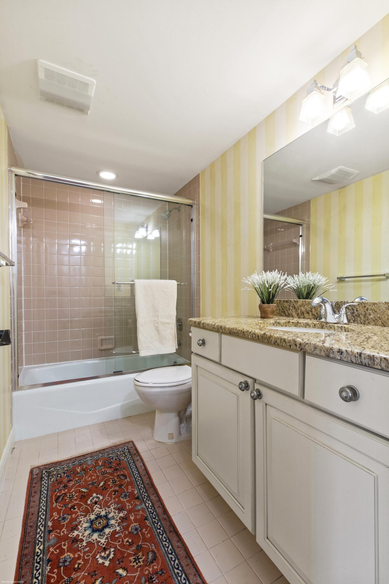 13244 Polo Club Road, Unit C206 Wellington, FL 33414 - Photo 14 of 46 a bathroom with a granite countertop sink and a mirror