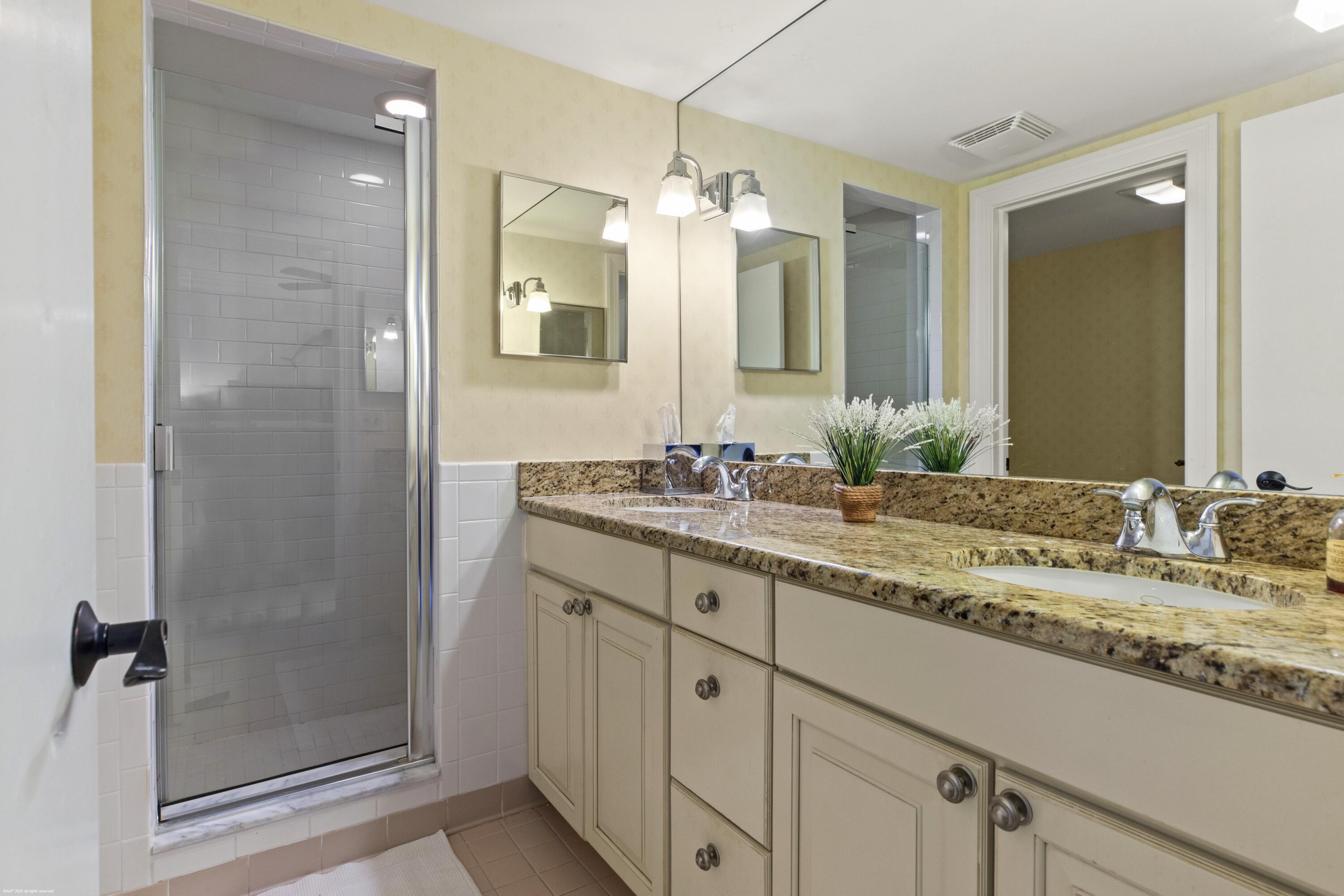 13244 Polo Club Road, Unit C206 Wellington, FL 33414 - Photo 16 of 46 a bathroom with a granite countertop sink and a mirror