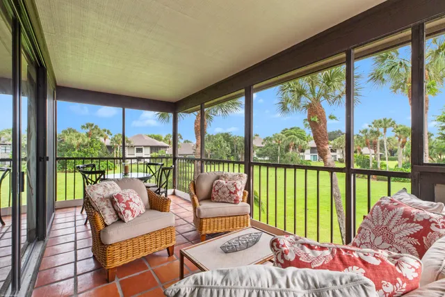 a bedroom with furniture and a large window