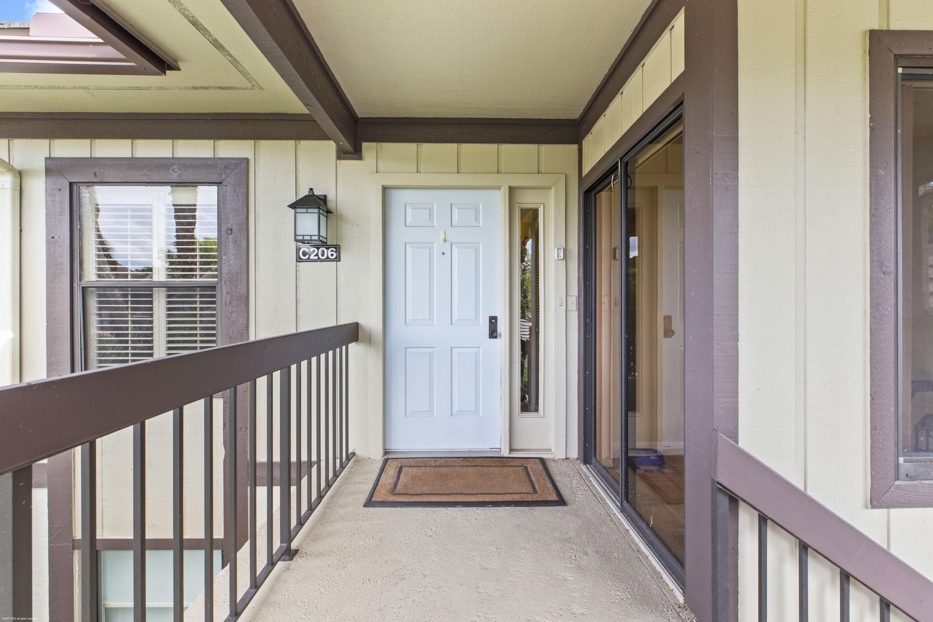 13244 Polo Club Road, Unit C206 Wellington, FL 33414 - Photo 30 of 46 a view of a porch with wooden floor and stairs