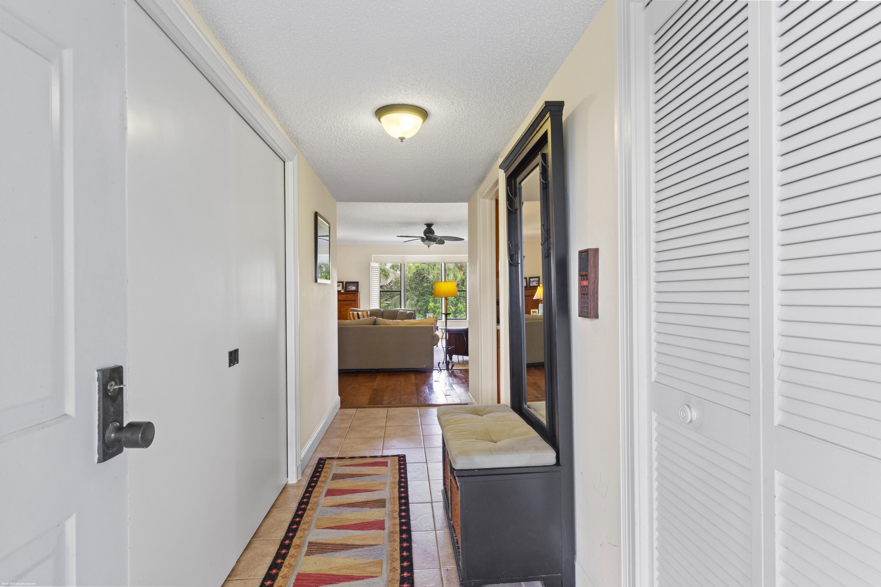13244 Polo Club Road, Unit C206 Wellington, FL 33414 - Photo 31 of 46 a living room with furniture and a gate