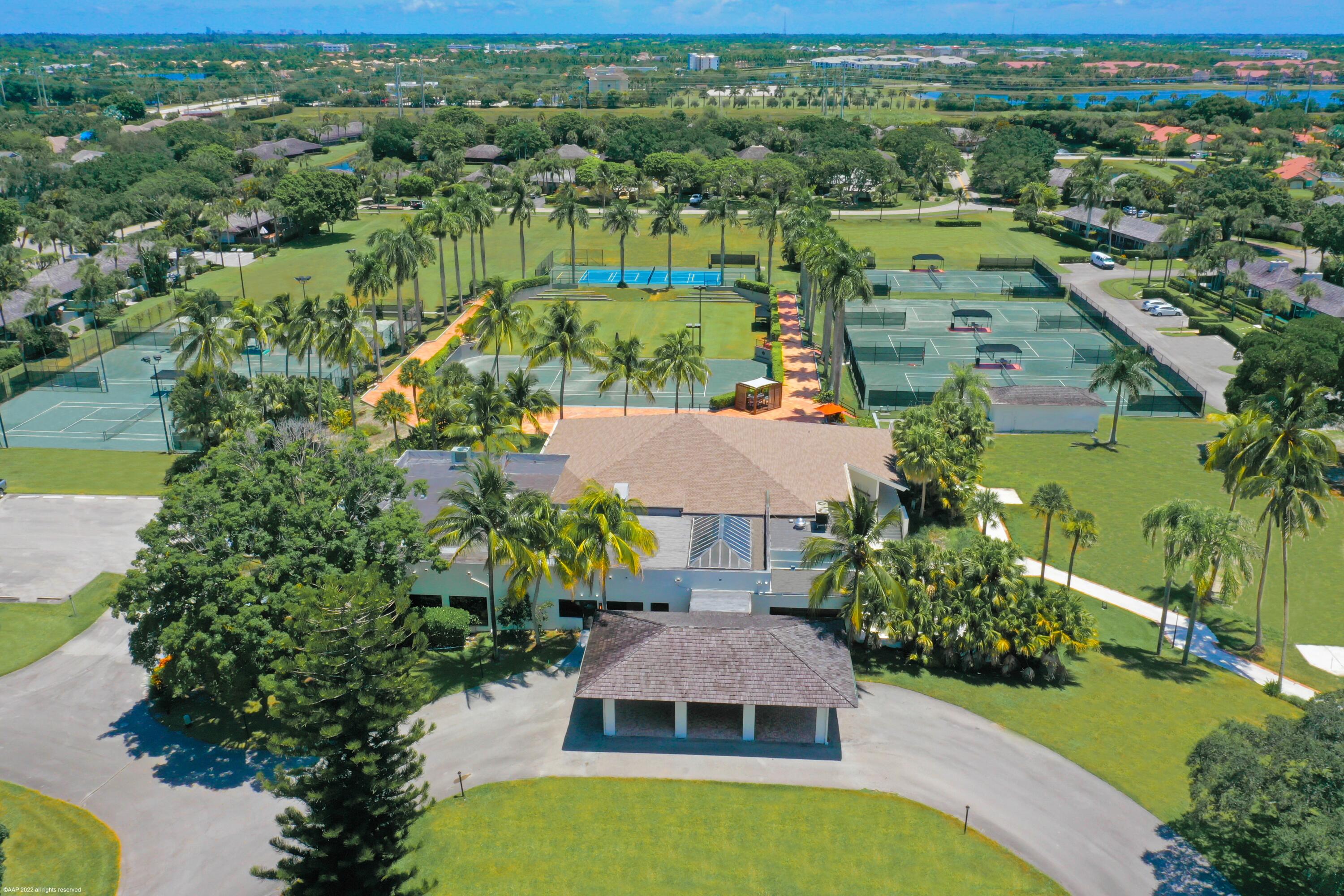 13244 Polo Club Road, Unit C206 Wellington, FL 33414 - Photo 37 of 46 an aerial view of residential houses with outdoor space and trees